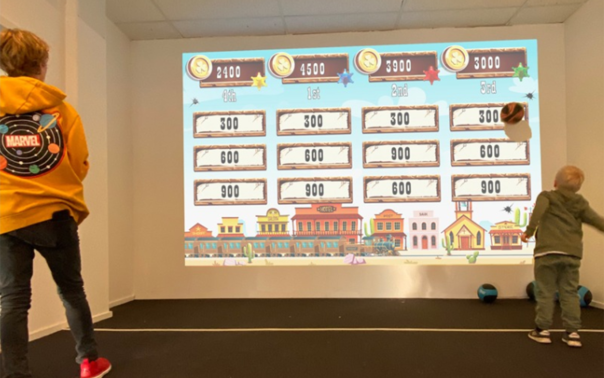 Young learners participating in sports activity on ActiveFloor SportsWall.